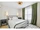 Bedroom featuring a wrought iron bed frame, green curtains and decorative lighting at 3532 Springbriar Dr, Castle Rock, CO 80109