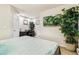 Bright bedroom showcasing a cozy bed, adjacent office space, and tasteful indoor plants at 3532 Springbriar Dr, Castle Rock, CO 80109
