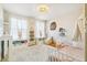Well-lit Bedroom with white carpet, organized shelving and crib at 3532 Springbriar Dr, Castle Rock, CO 80109