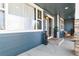 Charming covered front porch with a cozy seating area and decorative water fountain feature at 3532 Springbriar Dr, Castle Rock, CO 80109