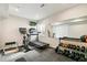 Home gym featuring treadmill, exercise bike, and free weights at 3532 Springbriar Dr, Castle Rock, CO 80109