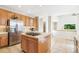 A kitchen with an island cooktop, stainless steel refrigerator, and an open layout for easy entertaining at 3532 Springbriar Dr, Castle Rock, CO 80109