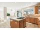 A kitchen with island cooktop, tile countertops and flooring and glass door to outdoor living space at 3532 Springbriar Dr, Castle Rock, CO 80109