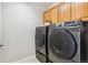 Laundry room featuring modern, front loading washer and dryer at 3532 Springbriar Dr, Castle Rock, CO 80109