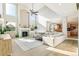 Bright living room featuring high ceilings, fireplace, large windows, and an open layout to the kitchen at 3532 Springbriar Dr, Castle Rock, CO 80109