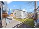 This backyard has a patio with outdoor seating and a privacy fence with a small playground at 652 S Race St, Denver, CO 80209