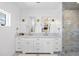 Elegant bathroom featuring a double vanity with marble countertops, stylish mirrors, and a glass-enclosed shower at 652 S Race St, Denver, CO 80209