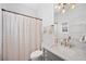 Cozy bathroom featuring marble countertop vanity and shower and tub with a pink and white curtain at 652 S Race St, Denver, CO 80209