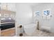 Bright bathroom features a freestanding tub with gold fixtures, two windows and view to the primary bedroom at 652 S Race St, Denver, CO 80209