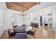 Elegant dining room with wood ceilings, statement chandelier, and open floor plan at 652 S Race St, Denver, CO 80209