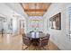 Bright dining room with wood ceilings, modern chandelier, hardwood floors, and natural light at 652 S Race St, Denver, CO 80209