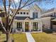 Charming two-story home features a welcoming front porch, well-manicured lawn, and modern exterior finishes at 652 S Race St, Denver, CO 80209