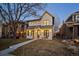 Charming two-story home with white siding, a metal roof, inviting front porch, and manicured lawn at 652 S Race St, Denver, CO 80209
