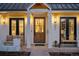 Cozy front porch with wood door, white columns, bench, and stylish lighting fixtures at 652 S Race St, Denver, CO 80209