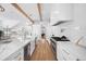 Spacious white kitchen with large island, modern appliances, hardwood floors, and breakfast bar at 652 S Race St, Denver, CO 80209