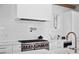 Modern kitchen with white subway tiles, pot filler faucet, stainless steel oven, and marble countertops at 652 S Race St, Denver, CO 80209