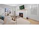 Inviting living room with brick fireplace, hardwood floors, and open access to outside patio at 652 S Race St, Denver, CO 80209