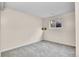 Finished basement bedroom with grey carpet, white walls, and window at 903 E 7Th Ave, Broomfield, CO 80020