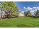 Expansive, well-maintained backyard featuring lush green grass and a wood fence at 500 Fulton St, Aurora, CO 80010