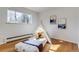 Bright bedroom featuring hardwood floors, a tent and a large window creating a playful space at 500 Fulton St, Aurora, CO 80010