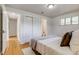 Well-lit bedroom with hardwood floors, closet, and en-suite bathroom access, offering convenience at 500 Fulton St, Aurora, CO 80010
