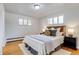 Charming bedroom features a wood headboard, bright windows, hardwood floors and a cozy atmosphere at 500 Fulton St, Aurora, CO 80010