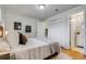Bright bedroom with hardwood floors, white walls, and ensuite bathroom, providing a serene retreat at 500 Fulton St, Aurora, CO 80010
