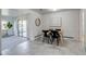 The dining room features gray tile flooring and is open to a sunroom and living room at 500 Fulton St, Aurora, CO 80010