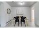 Open dining room featuring tile floors, a minimalist light wood table, and black chairs at 500 Fulton St, Aurora, CO 80010