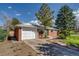 Charming brick home with attached garage, mature trees, and well-maintained landscaping at 500 Fulton St, Aurora, CO 80010