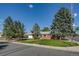 Charming red brick home on a corner lot featuring mature trees and a well-maintained lawn at 500 Fulton St, Aurora, CO 80010
