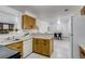 Functional kitchen featuring classic cabinets, stainless steel sink and adjacent dining area at 500 Fulton St, Aurora, CO 80010