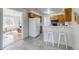 Bright kitchen with a breakfast bar, ample counter space, tile floors, and white appliances at 500 Fulton St, Aurora, CO 80010