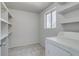 Bright laundry room equipped with shelving and a washing machine, offering practical storage solutions at 500 Fulton St, Aurora, CO 80010