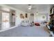 Spacious living room with a stone fireplace, neutral carpet, and an open layout at 500 Fulton St, Aurora, CO 80010
