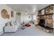 Charming living room featuring a distinctive stone fireplace and comfortable seating at 500 Fulton St, Aurora, CO 80010