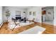 Inviting living room featuring hardwood floors, a sleek black sofa, and contemporary decor at 500 Fulton St, Aurora, CO 80010