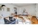 Open living room with hardwood floors, a black sofa, and modern decor leading to dining area at 500 Fulton St, Aurora, CO 80010