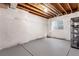 Unfinished basement space with bright egress windows, perfect for storage at 5723 S Union Ct, Littleton, CO 80127