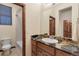 Bathroom with granite countertop, wood cabinets, and a tile shower and tub combo at 5723 S Union Ct, Littleton, CO 80127
