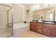 The spacious primary bathroom features a soaking tub, dual sinks, and a separate shower at 5723 S Union Ct, Littleton, CO 80127