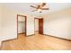 Bedroom features ample closet space, wooden doors and trim, and hardwood floors at 5723 S Union Ct, Littleton, CO 80127