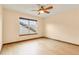 Bright bedroom features natural light, ceiling fan, and hardwood flooring at 5723 S Union Ct, Littleton, CO 80127