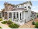 Charming home with stone accents, a covered porch, and manicured landscaping at 5723 S Union Ct, Littleton, CO 80127