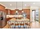 Gourmet kitchen featuring hardwood floors, a center island with seating, and stainless steel appliances at 5723 S Union Ct, Littleton, CO 80127