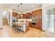A spacious kitchen features an island with pendant lighting, stainless appliances, and wooden cabinetry at 5723 S Union Ct, Littleton, CO 80127