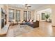 Comfortable living room with hardwood floors, natural light, and seamless access to the dining area at 5723 S Union Ct, Littleton, CO 80127