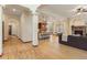 Open-concept living space featuring hardwood floors, a fireplace, and seamless transition to the kitchen at 5723 S Union Ct, Littleton, CO 80127