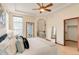 The bright primary bedroom has views of the ensuite and has a ceiling fan at 5723 S Union Ct, Littleton, CO 80127