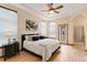 Comfortable primary bedroom features a tray ceiling, a ceiling fan, and large windows at 5723 S Union Ct, Littleton, CO 80127